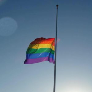 gay flag half mast